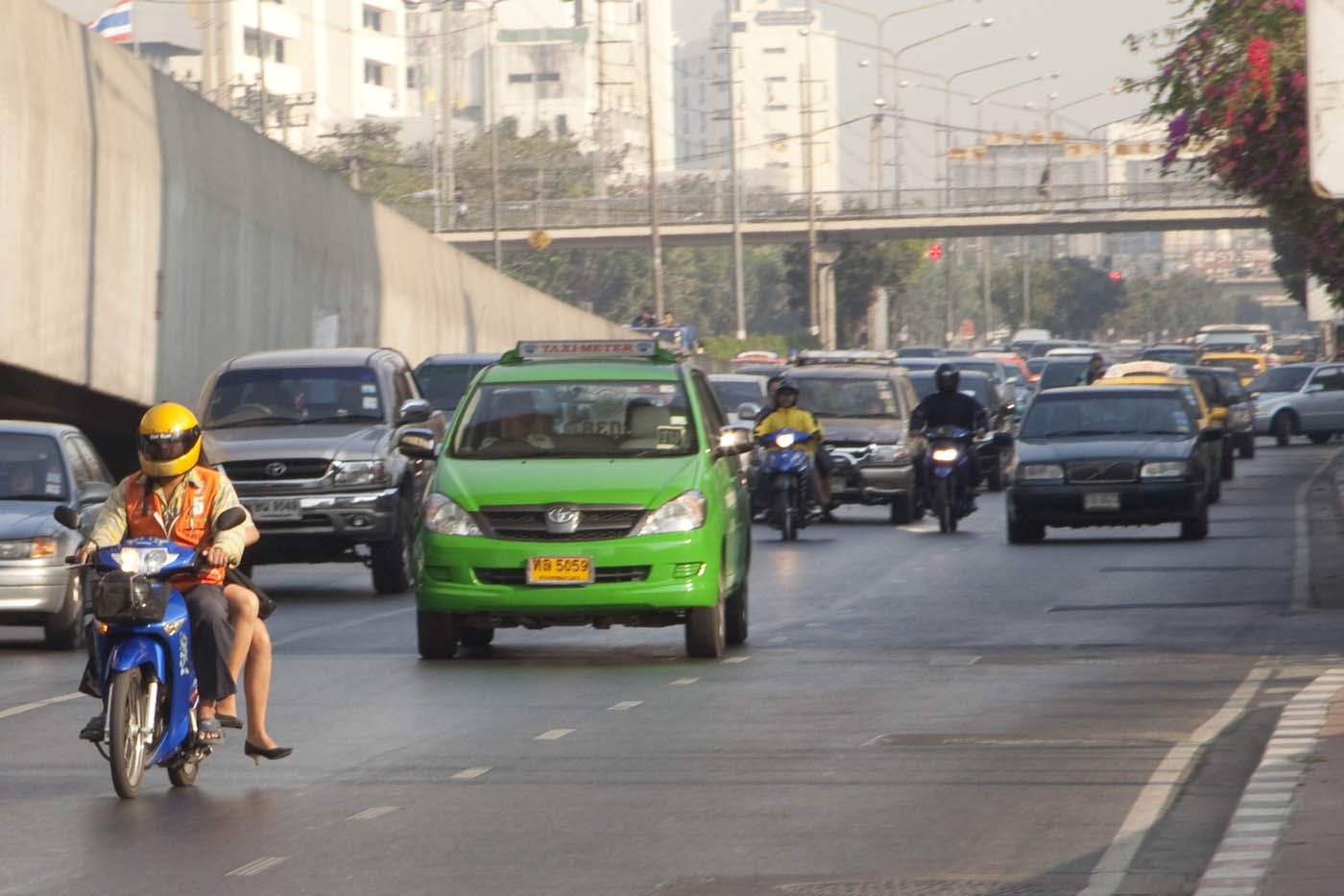 Bangkok traffic with woman on motorcycle taxi