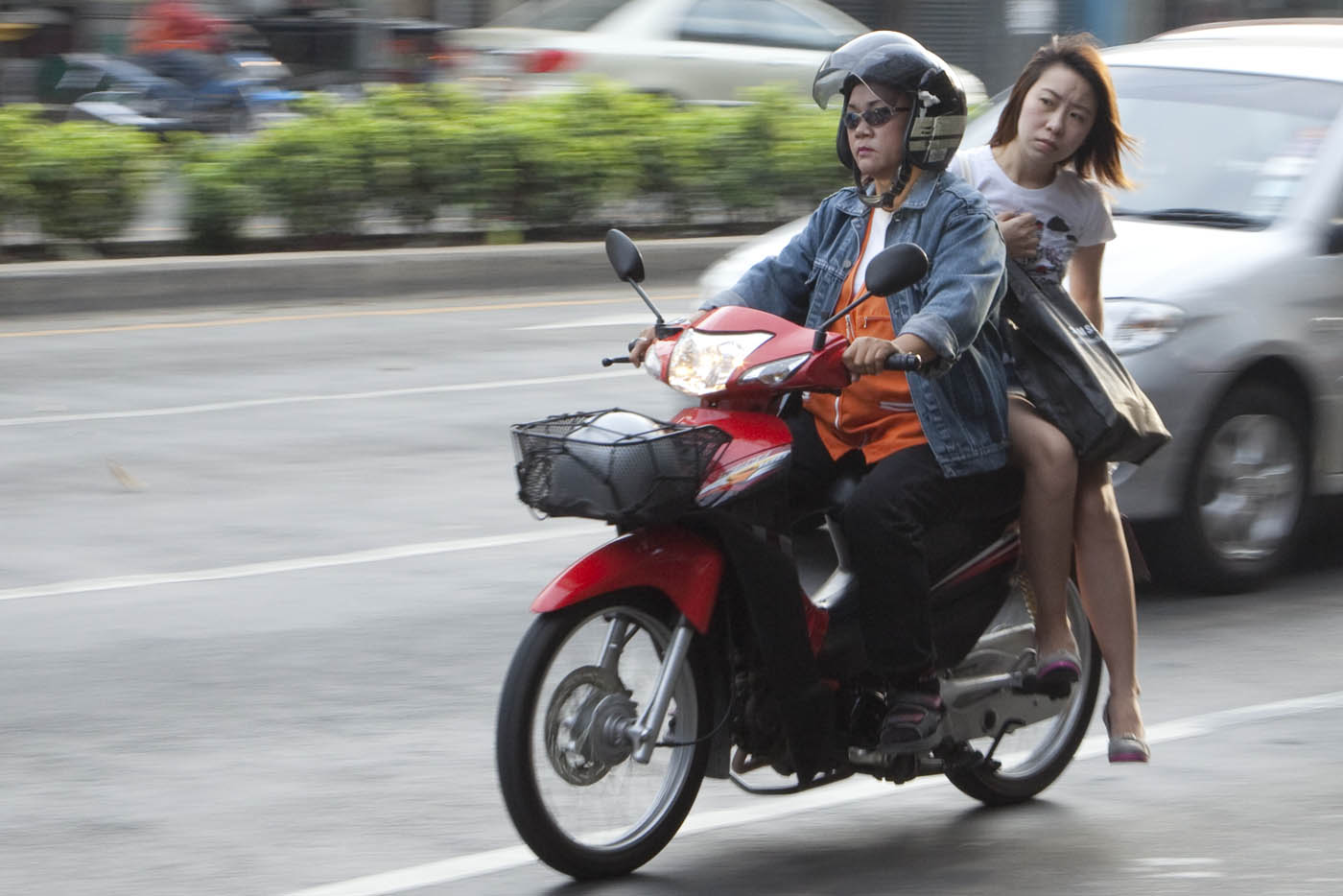 female Bangkok motorcycle taxi driver with female passenger