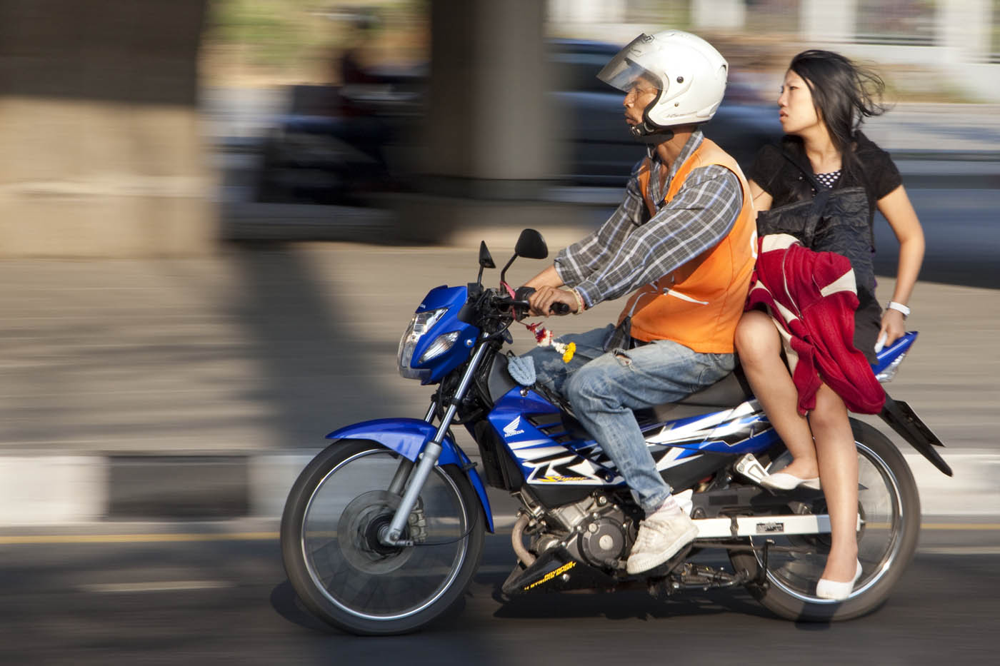 Bangkok office worker taking a motorcycle taxi