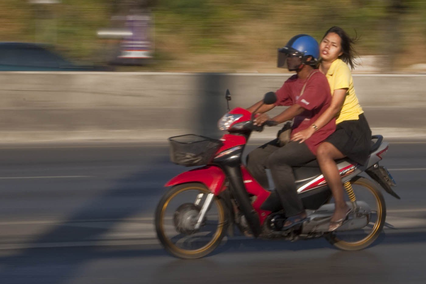woman rides on Bangkok motorcycle taxi